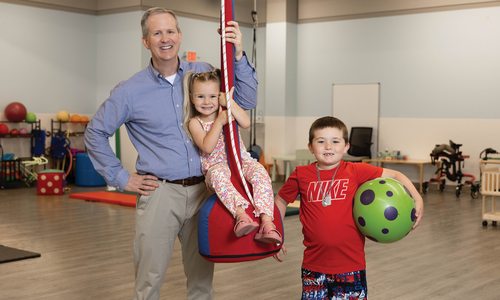 Dr. John and two patients at Autism and Neurodevelopmental Center.