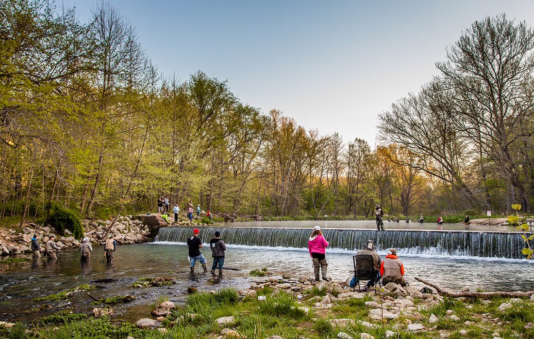 People sightseeing at a river in Montauk State Park, Missouri