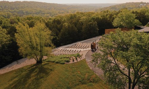 An outdoor wedding chapel overlooks the Finley River, the Riverside Bridge and rushing waterfalls.